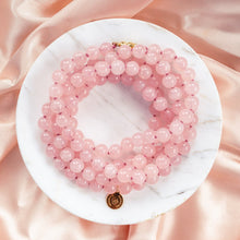 Load image into Gallery viewer, Elegant and exclusive hand-knotted Rose Quartz collier necklace with 119 high grade gemstones and details in 18k gold-plated 925 sterling silver. Presented on marble and pink silk fabric for a luxury feeling.
