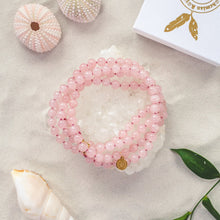 Load image into Gallery viewer, Elegant and exclusive hand-knotted Rose Quartz collier necklace with 119 high grade gemstones and details in 18k gold-plated 925 sterling silver. Presented on a crystal cluster beach style.
