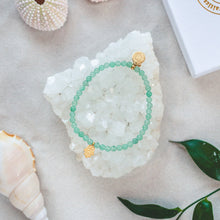 Load image into Gallery viewer, Elegant and unique Green Aventurine bracelet with a hamsa charm and details in 18k gold-plated 925 Sterling Silver and brass. Presented on a crystal cluster beach style.
