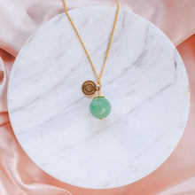 Load image into Gallery viewer, Unique and minimalistic 80 cm long Green Aventurine necklace with a faceted gemstone. Presented on marble and pink silk.
